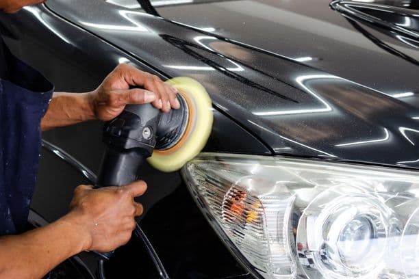 Car being polished with an electric buffer