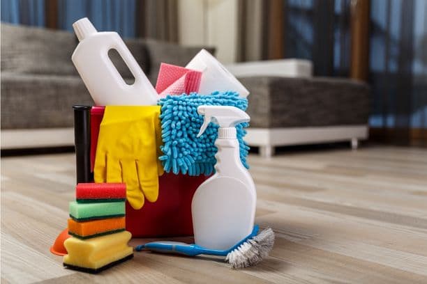 Bucket of cleaning supplies with gloves and sponges