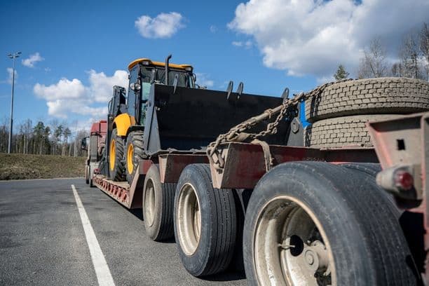 Construction loader secured on a flatbed trailer