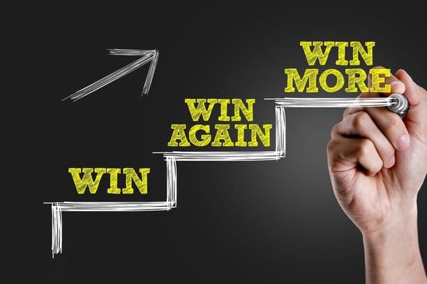 Chalkboard graphic reading 'Win more'