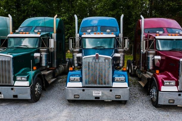 Three semi trucks parked side by side