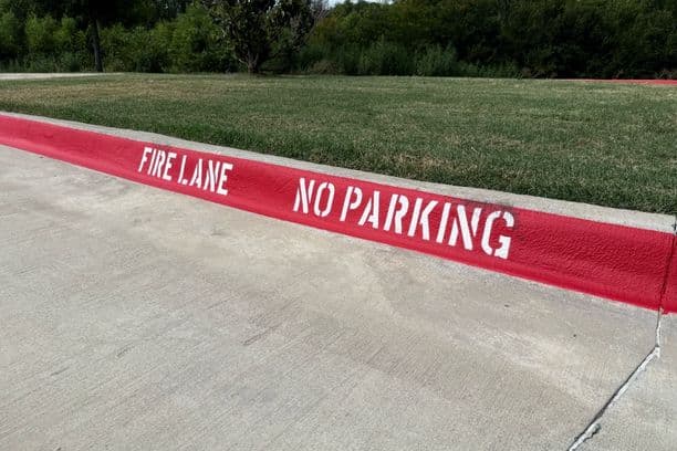 Red curb painted with 'Fire Lane No Parking'